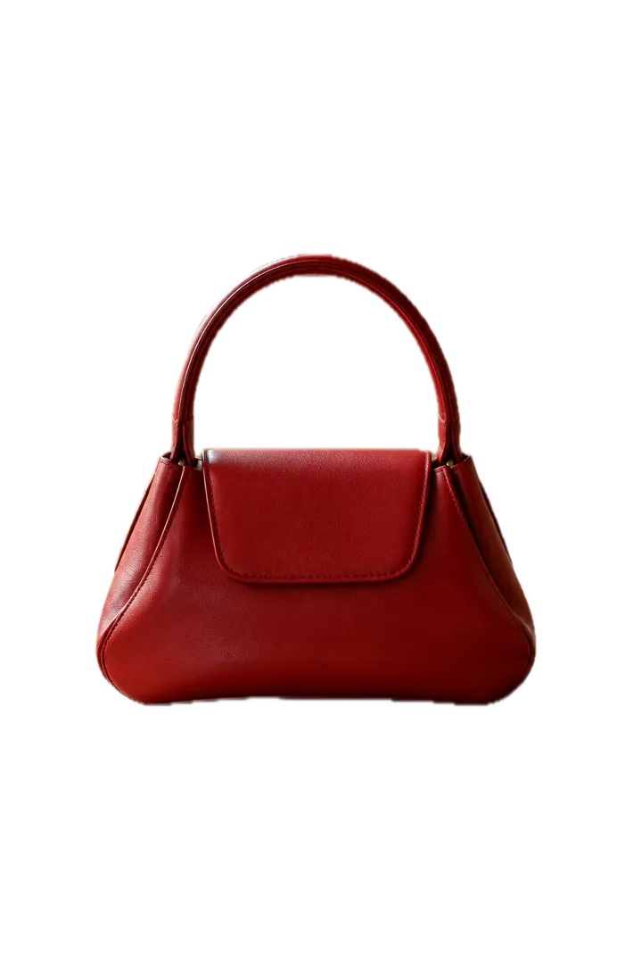 A red handbag cut out onto a plain white background